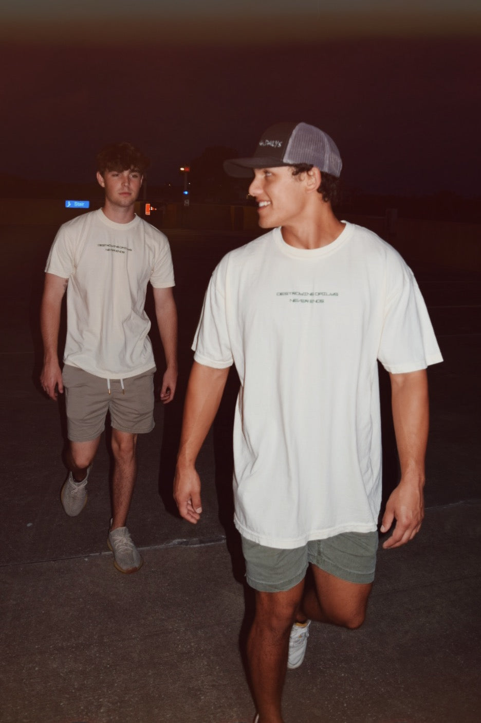 Male models wearing White 100% cotton t-shirt featuring green hand-drawn Porsche 911 GT3 RS designs with the text "Destroying Dailys The Pursuit of Perfection A Never Ending Journey," perfect for car enthusiasts.