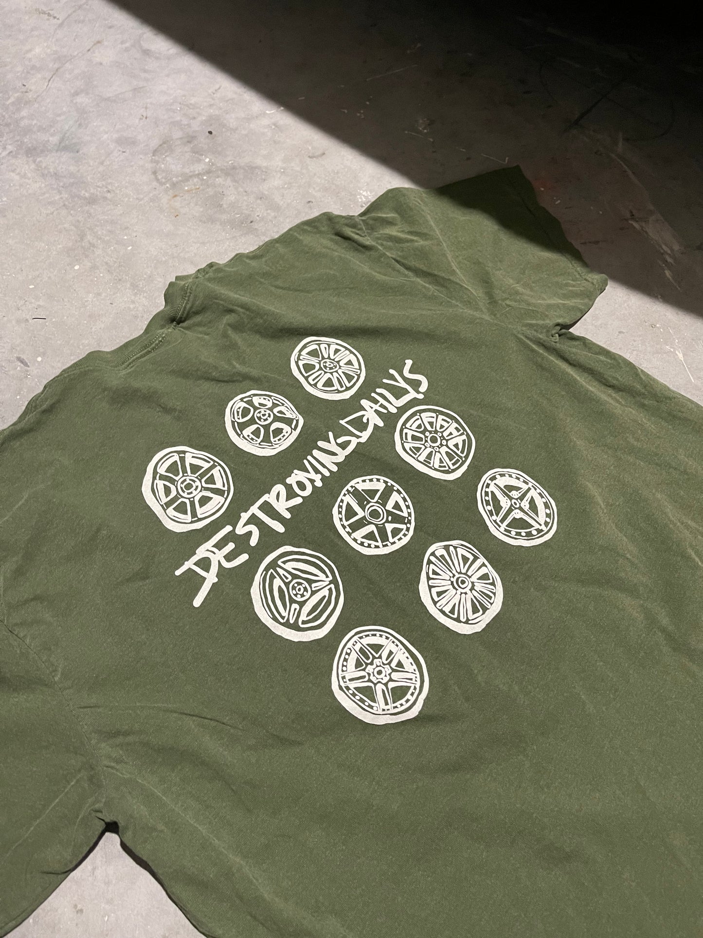 Green 100% cotton t-shirt featuring a hand-drawn JDM wheel design with the text "Destroying Dailys," perfect for car enthusiasts.