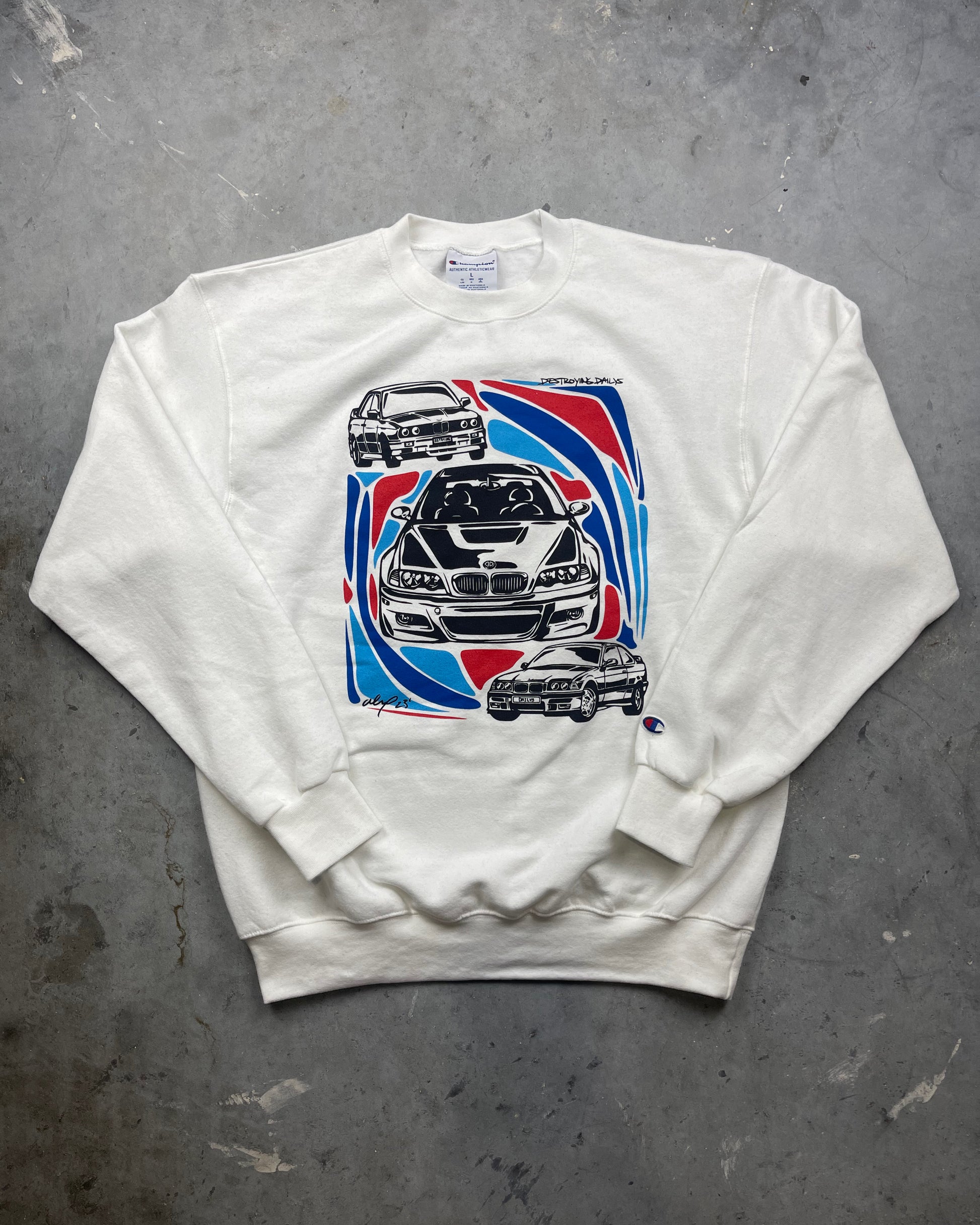 detailed photo of White crewneck sweatshirt made of 50/50 cotton and polyester blend featuring hand-drawn BMW E30, E36, and E46 M3s with red, blue, and black accents, perfect for car enthusiasts. Bmw sweatshirt for car guys