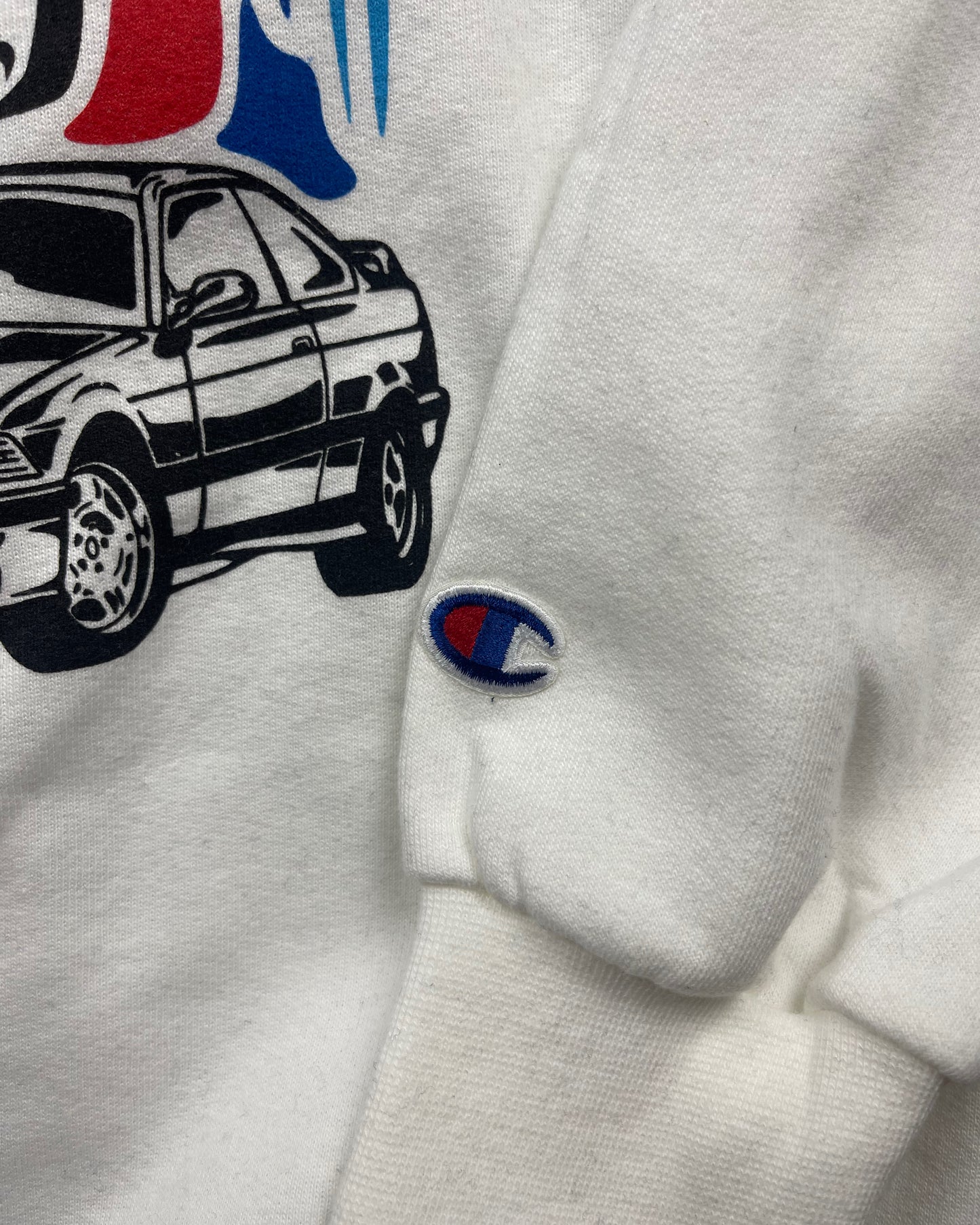 sleeve shot of White crewneck sweatshirt made of 50/50 cotton and polyester blend featuring hand-drawn BMW E30, E36, and E46 M3s with red, blue, and black accents, perfect for car enthusiasts. Bmw sweatshirt for car guys