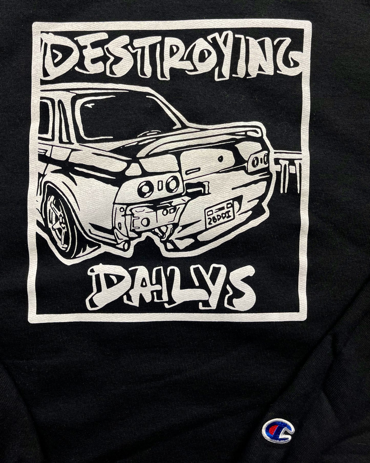  close up front view of Black crewneck sweatshirt made of 50/50 cotton and polyester blend featuring a hand-drawn JDM Skyline R32 with the text "Destroying Dailys," perfect for car enthusiasts. JDM sweatshirt for car guys, Nissan Skyline sweatshirt