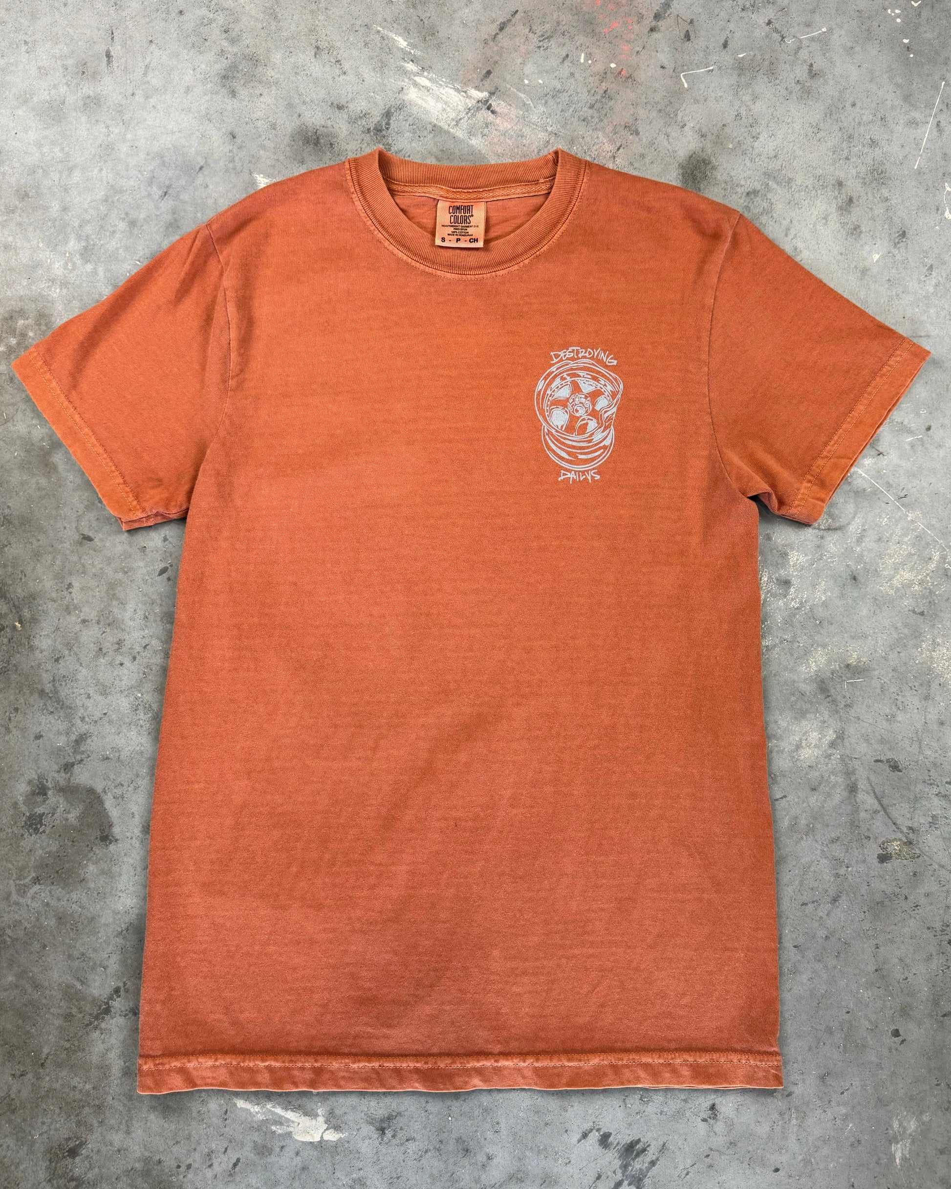 Front view of Orange 100% cotton t-shirt featuring a hand-drawn design of JDM wheels with the text "Destroying Dailys," perfect for car enthusiasts. 