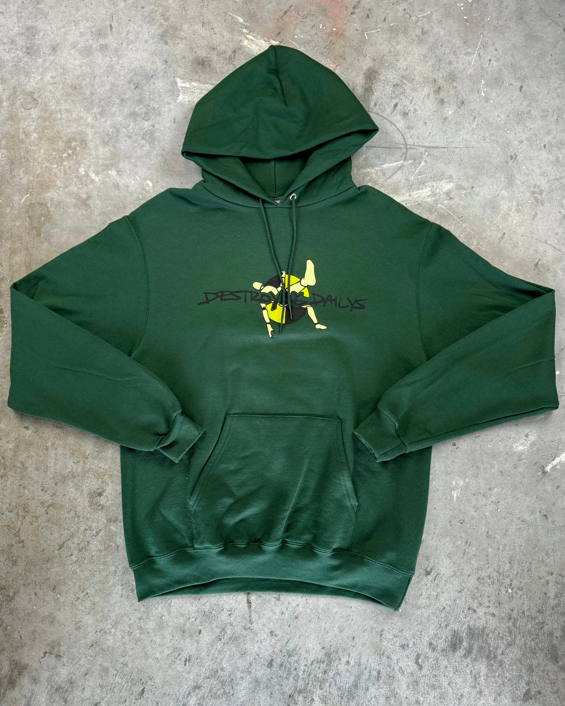 Front of Dark green hoodie made of 50/50 cotton and polyester blend featuring a hand-drawn crash test dummy with the text "Be A Dummy... Destroy the Daily: Destroying Dailys," perfect for modified car enthusiasts.