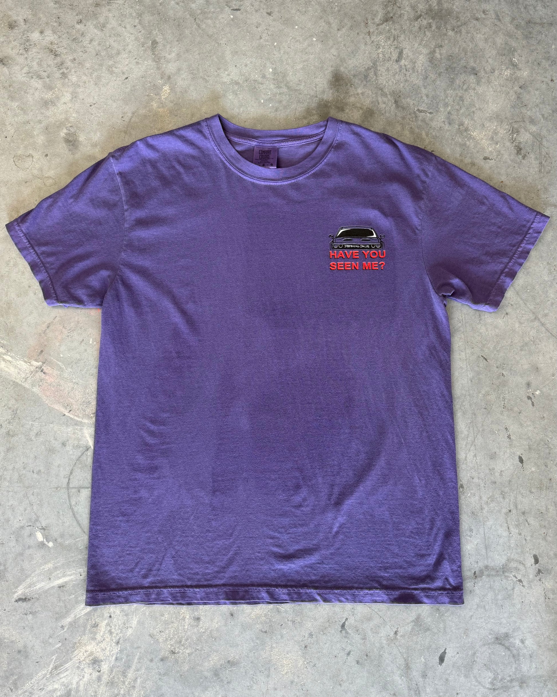 Purple hand-drawn dodge challenger hellcat T-shirt featuring a unique design of a missing Dodge Challenger Hellcat on a milk carton with a glass of milk. Text includes 'Got Keys?' and 'Destroying Days.' Made from soft 100% cotton, pre-shrunk, and garment dyed. Perfect for car enthusiasts and Dodge Challenger Hellcat fans. Comfortable casual wear with a creative, artistic touch. Close up front of tee shirt with dodge challenger T shirt design on front