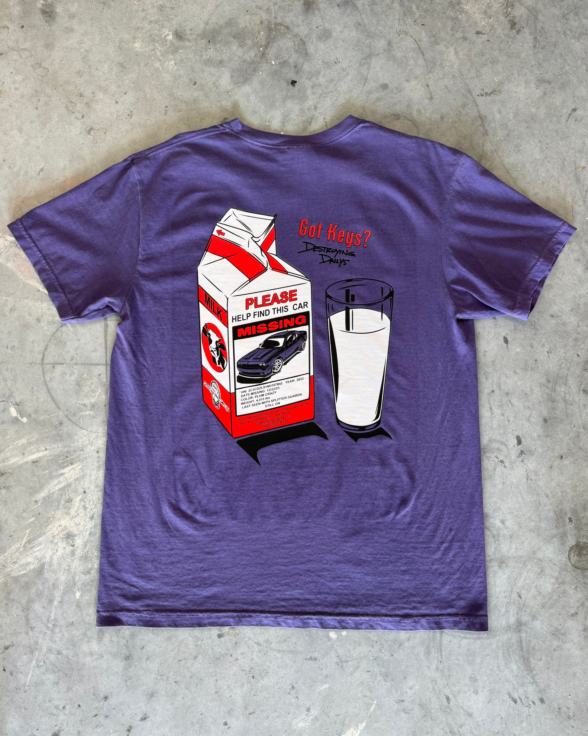 Purple hand-drawn dodge challenger hellcat T-shirt featuring a unique design of a missing Dodge Challenger Hellcat on a milk carton with a glass of milk. Text includes 'Got Keys?' and 'Destroying Days.' Made from soft 100% cotton, pre-shrunk, and garment dyed. Perfect for car enthusiasts and Dodge Challenger Hellcat fans. Comfortable casual wear with a creative, artistic touch. close detailed back of t shirt