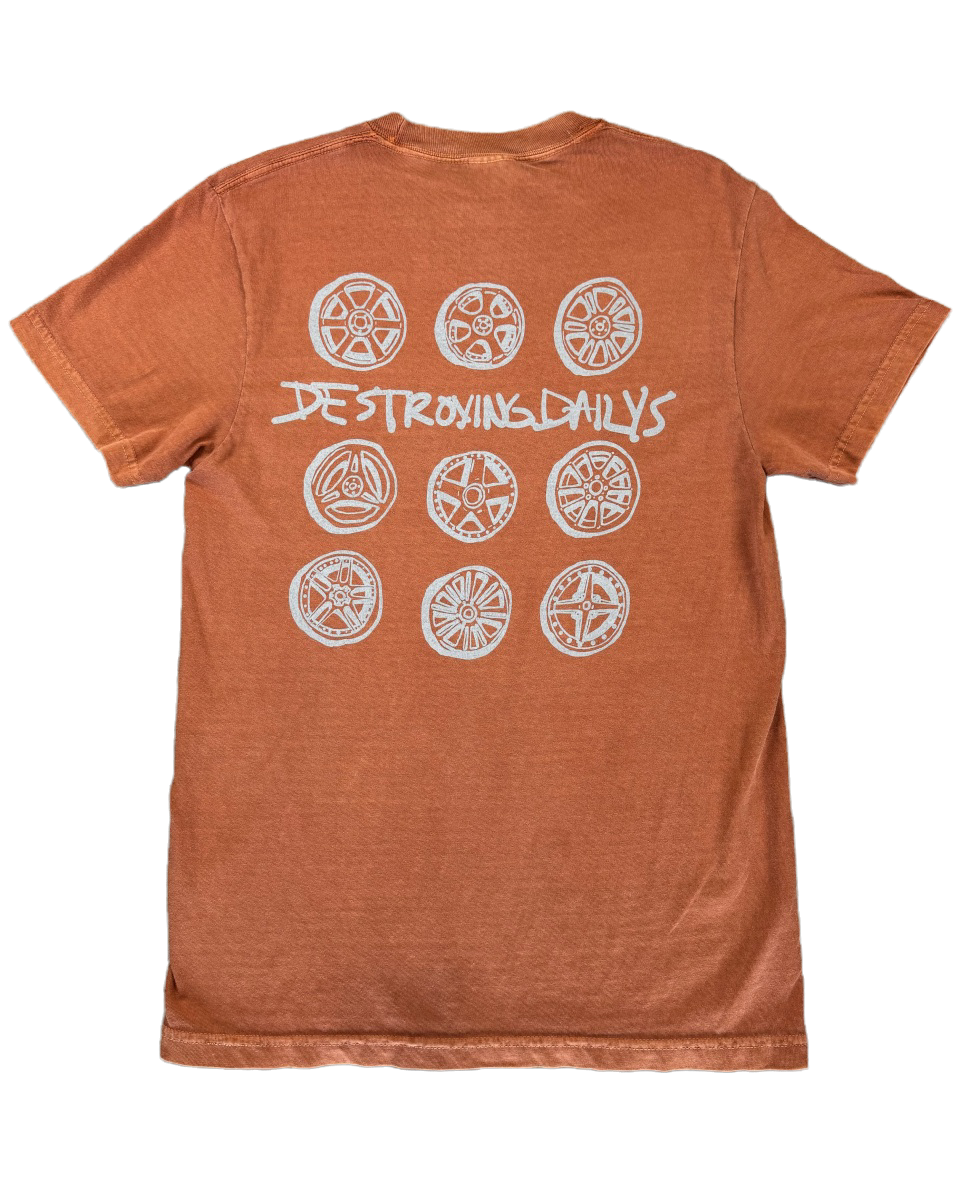 Orange 100% cotton t-shirt featuring a hand-drawn design of JDM wheels with the text "Destroying Dailys," perfect for car enthusiasts.