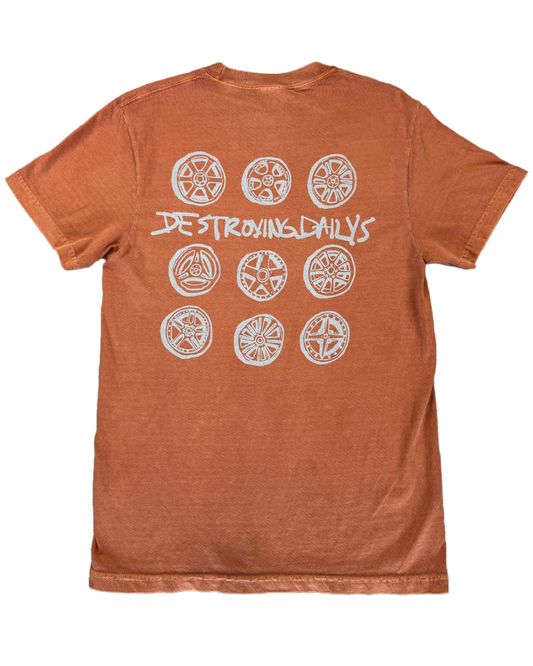 Orange 100% cotton t-shirt featuring a hand-drawn design of JDM wheels with the text "Destroying Dailys," perfect for car enthusiasts.