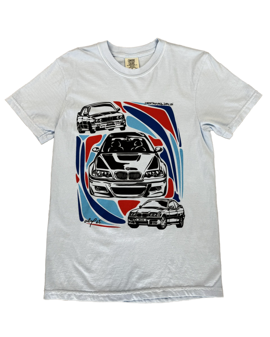 Light blue 100% cotton t-shirt featuring hand-drawn BMW E30, E36, and E46 designs with red, blue, and black accents, ideal for car enthusiasts.