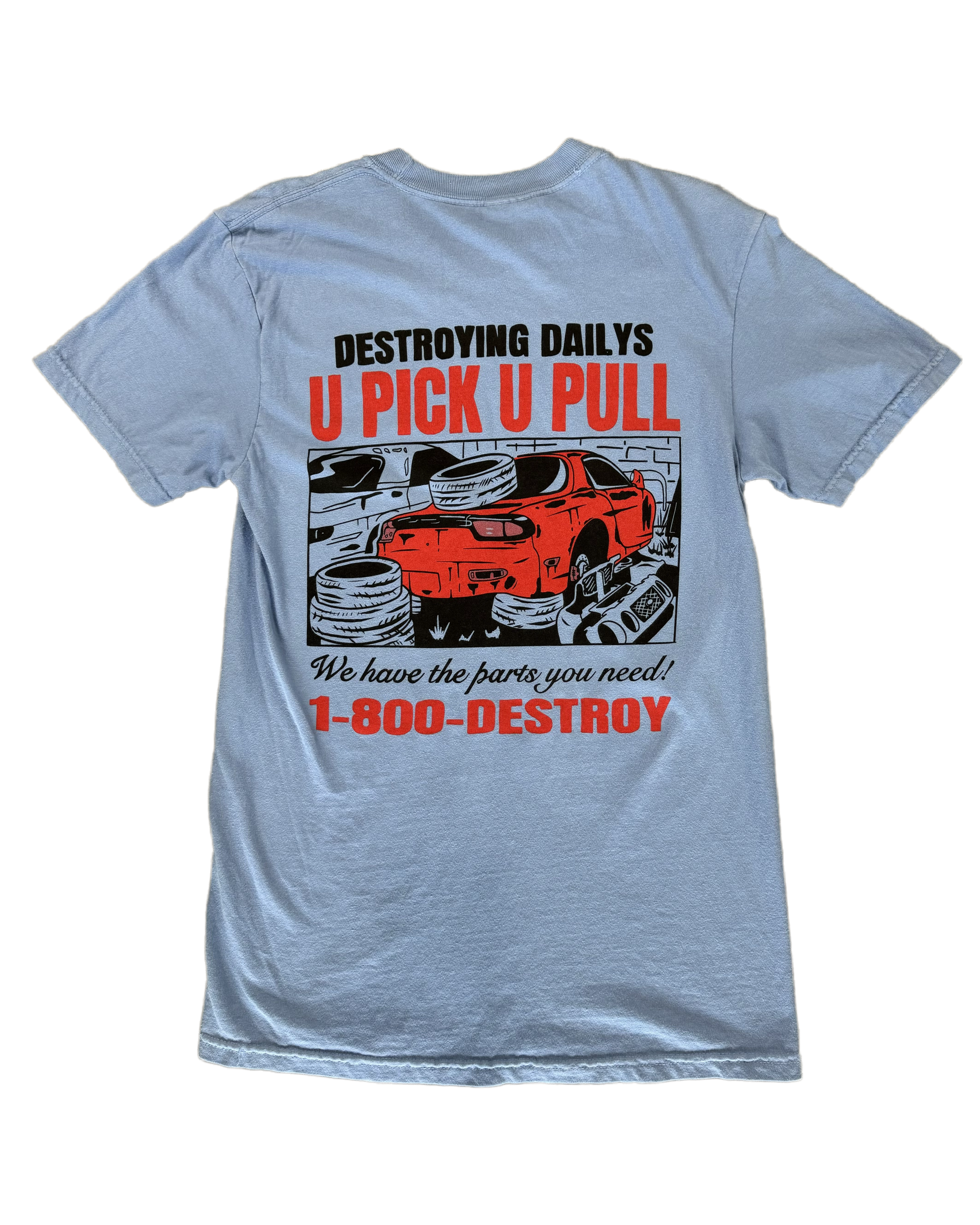 Light blue 100% cotton t-shirt featuring a hand-drawn JDM Rx-7 at a scrapyard with the text "Destroying Dailys U Pick U Pull 1-800-DESTROY," ideal for car enthusiasts