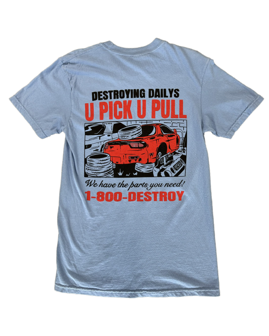 Light blue 100% cotton t-shirt featuring a hand-drawn JDM Rx-7 at a scrapyard with the text "Destroying Dailys U Pick U Pull 1-800-DESTROY," ideal for car enthusiasts