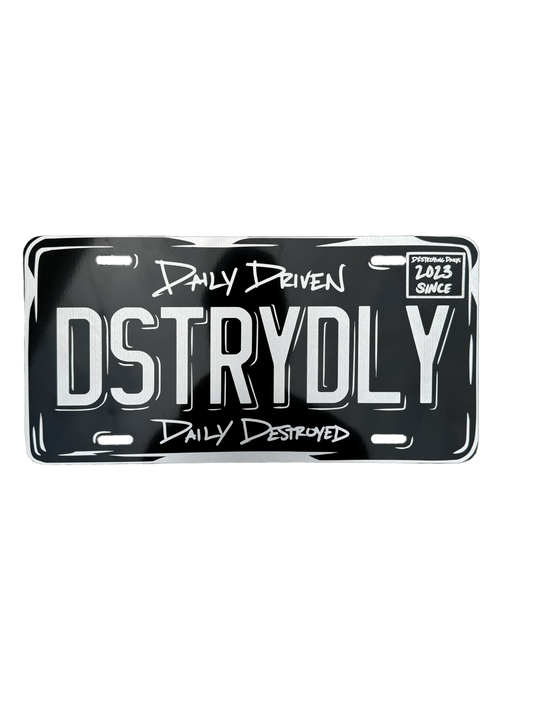 12x6 inch aluminum vanity plate featuring "DSTRYDLY" text with "Daily Driven, Daily Destroyed" and "Destroying Dailys Since 2023," perfect for car enthusiasts. Custom plate for car enthusiasts